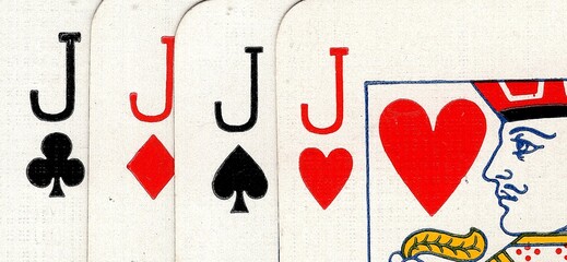 Close up detail of four playing cards of the same value.