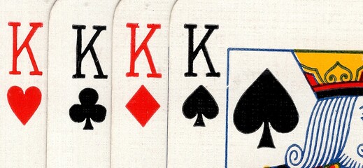 Close up detail of four playing cards of the same value.