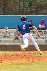Baseball Player Rounding Third Base Trying to Score