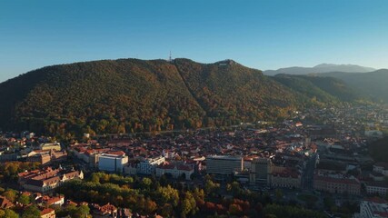 Drone shot of Brasov center at sunset in autumn 2025