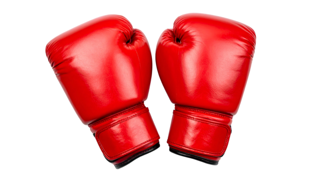 Two vibrant red boxing gloves are isolated against a black backdrop, ready for action