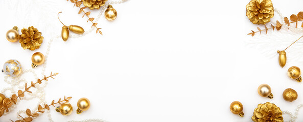 Elegant winter background with golden baubles, acorns and pine cones. White minimalist Christmas copy space.