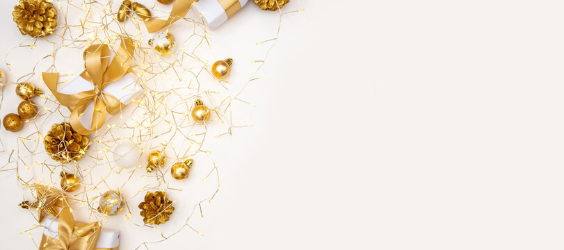 Merry Christmas and Happy New Year greeting card, frame, and banner. Holidays design. Noel and Feliz Navidad. Gifts and decorations, top view, flat lay. Text space, copy space winter background.