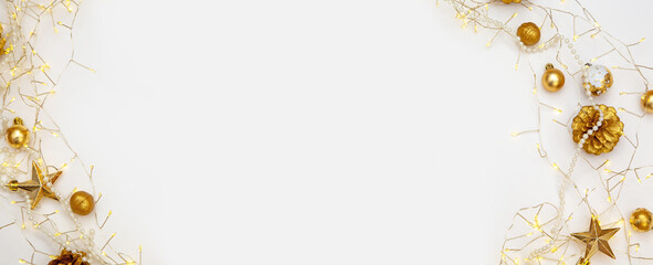 Soft golden lights and Christmas decorations on white background. Elegant minimal festive frame with copy space.