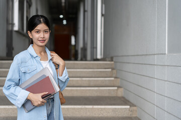 Portrait beautiful Asian woman student. Smile girl happy study. read book in college campus. young female on international Asia University. Education, study, school, learning, exam, continue education