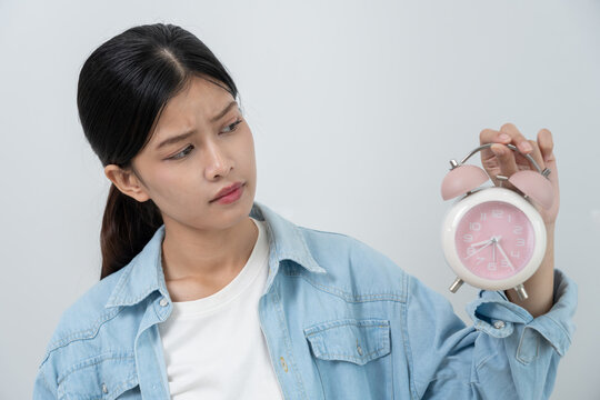 Stress Asia young woman show clock alarm, lady is late appointment or work or class study, overslept, difficulty get up in mornings, time worried, not on time, sleepy, over due, Hurry up time