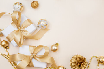 Luxury Christmas and New Year background with gifts, golden ribbons and ornaments. Elegant minimal composition with copy space.