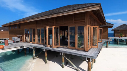 Luxury resort photo of Maldives tropical paradise island in Indian Ocean with palm trees, overwater thatched bungalows. Beautiful photography, coral reef, azure ocean, sky with clouds. 