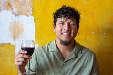 Guy toasting with a glass of wine