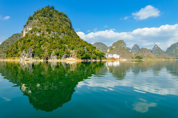 Fototapeta premium Quyang Lake (Quyanghu) karst peaks landscape reflection in water in Baise city, Guangxi province, China