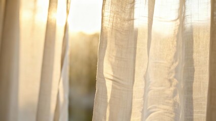 Golden morning sunlight streaming through sheer linen window curtains, creating a warm and peaceful glow.