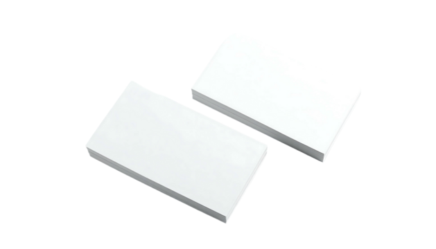 Two neat stacks of white rectangular paper sit diagonally on a solid black surface, casting soft shadows