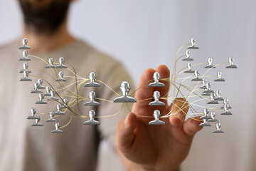 Hand reaching towards a digital network with connected people icons, illustrating teamwork,...