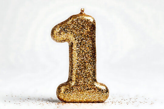 Sparkling gold glitter number one candle perfect for celebrating first birthdays, anniversaries, or milestone achievements with festive flair