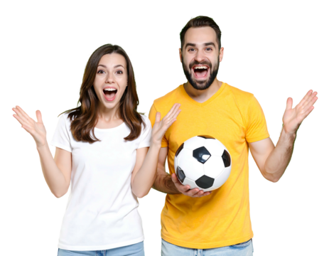 Couple in t-shirts, arms raised, jubilant; male holds soccer ball against black. Cheerful, excited, and sporty pose