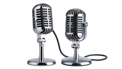 Two silver vintage microphones stand close against a black background, connected by a short black wire