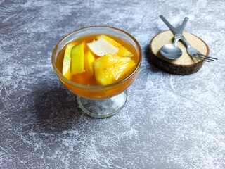 Asinan buah or pickled fruit in a bowl on a gray background. fresh Indonesian dessert spicy, sweet, and sour taste 