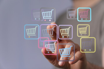 Person interacting with digital shopping cart symbols, representing online shopping, e-commerce, and digital transactions.