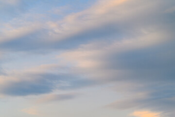 A Serene Sky Awash with Soft Clouds as the Day Transitions into the Beautiful Dusk