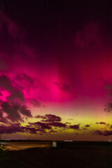 Vibrant Aurora Borealis Over Rural Landscape
