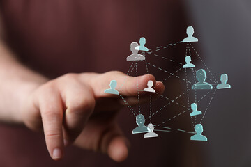 Hand reaching towards a digital network illustration representing connection, communication, and...