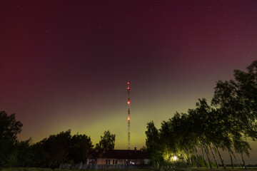 Obraz premium Aurora Borealis Over Rural Landscape with Antenna