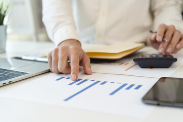 Deduction planning, debt asian accountant hand using calculator to calculating money balance from...