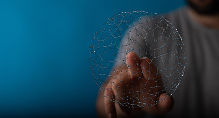 A person extending a hand towards a digitally connected sphere, symbolizing technology, networks, and global communication on a blue background.