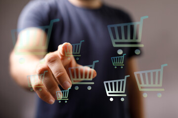 Person interacting with digital shopping cart icons, representing online shopping, e-commerce, and...