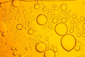 Close-up yellow macro drink bubble texture,close up of glass with beer, yellow background, bubbles...