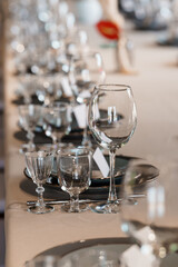 Elegant Wedding Table Setting with Crystal Glassware, Fine China, and Beige Linen. Luxurious Event Decor, Champagne Glasses, Formal Dinner Scene.