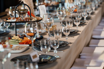 Elegant Wedding Reception Table Setting with Charcuterie, Wine Glasses, and Gray Linens: Luxurious Celebration Decor