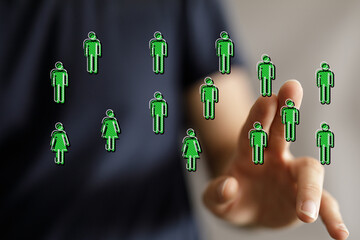 Concept of networking, connecting, and interaction. Finger touching digital people, representing virtual connections and online communities.