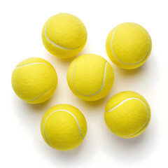 A top down view of six yellow tennis balls arranged on a plain white surface in a studio setting