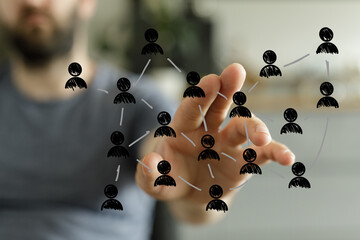 Visualize connection, teamwork, and business networking with this conceptual image. A hand interacts with a digital illustration of a network.
