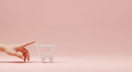 Woman's hand gently pushing a white cart icon on pink background