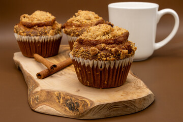 Pumpkin Muffins with Cinnamon and Coffee – Freshly Baked Autumn Pastry on Wooden Board