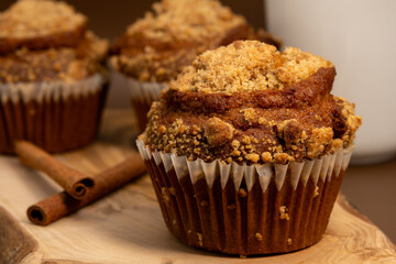 Close-Up of Pumpkin Muffin with Cinnamon Sticks – Warm Autumn Dessert with Crumb Topping