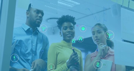 Brainstorming team analyzing glass board in office area, with markers and colorful sticky notes