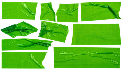 Collection of torn, crumpled, and overlapping green tape pieces against a black background