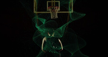 Standing basketball player wearing dark jersey and shorts under hoop and net, glowing green mesh