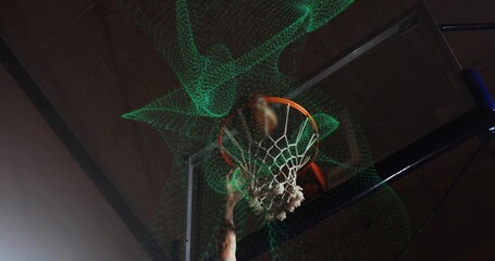 Slam dunking jersey-clad athlete arm smashing rim net and backboard under green particles in gym © vectorfusionart
