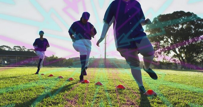 Practicing agility drills three female baseball players wearing uniforms on turf with orange cones - Powered by Adobe