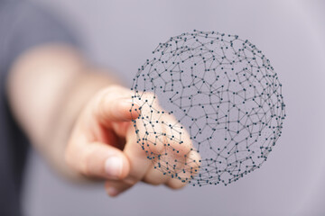 A person's hand interacting with a 3D rendered sphere network.  Represents connectivity, data, the...