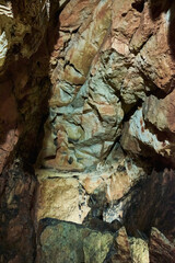 Vadu Crisului Cave in Bihor, Romania, features impressive limestone formations. Stalactites hang from the ceiling, while stalagmites rise from the floor, some meeting to form columns