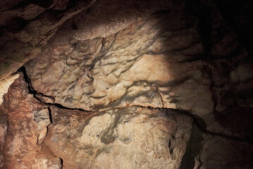 Vadu Crisului Cave in Bihor, Romania, features impressive limestone formations. Stalactites hang...