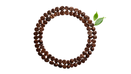 A circular frame of roasted beans, accented by fresh leaves, against a black background
