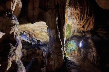 Vadu Crisului Cave in Bihor, Romania, features impressive limestone formations. Stalactites hang...