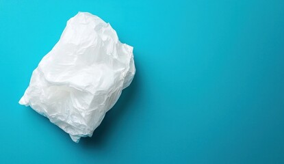 Crumpled Plastic Bag on Bright Blue Background for Environmental Themes