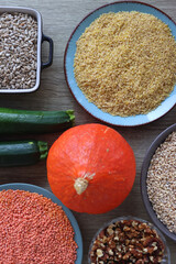 Assortment of various healthy fruits, vegetables, grains and legumes. Top view, wooden background.